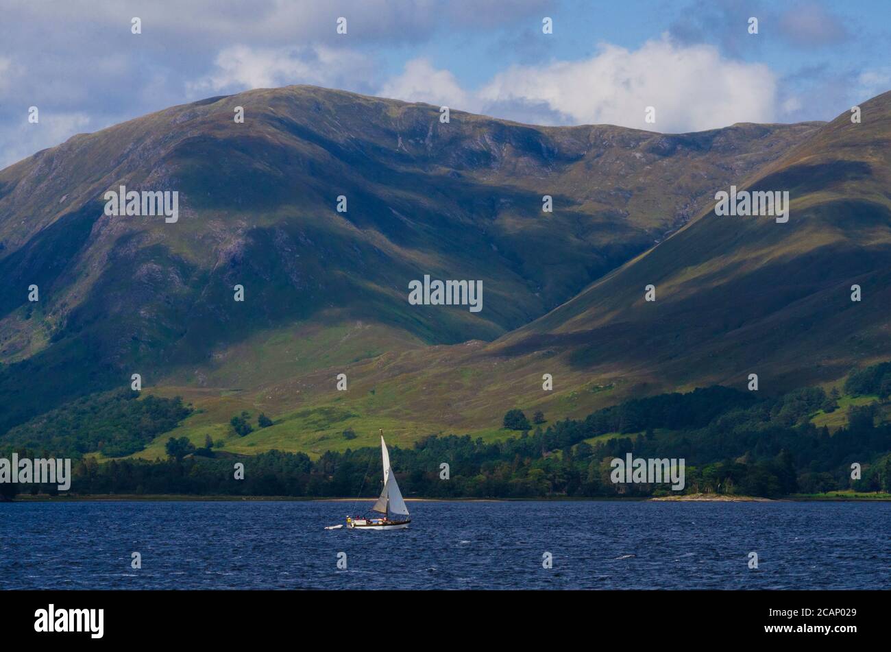 A 25ft yacht makes it's way up Loch Linnhe towards Fort William on the the west coast of Scotland UK Stock Photo
