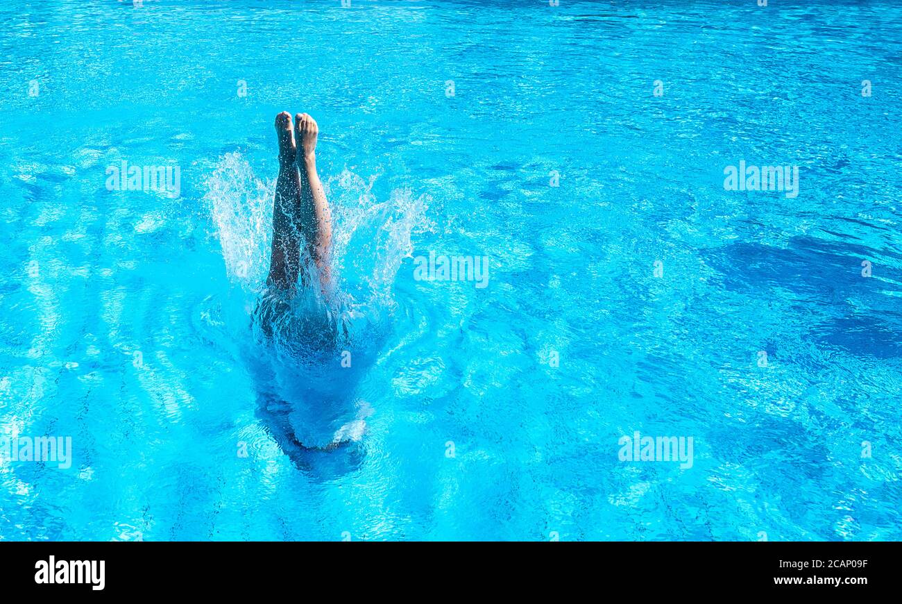 07 August 2020, Baden-Wuerttemberg, Stuttgart: A woman dives into the pool in the Inselbad. Photo: Sebastian Gollnow/dpa Stock Photo