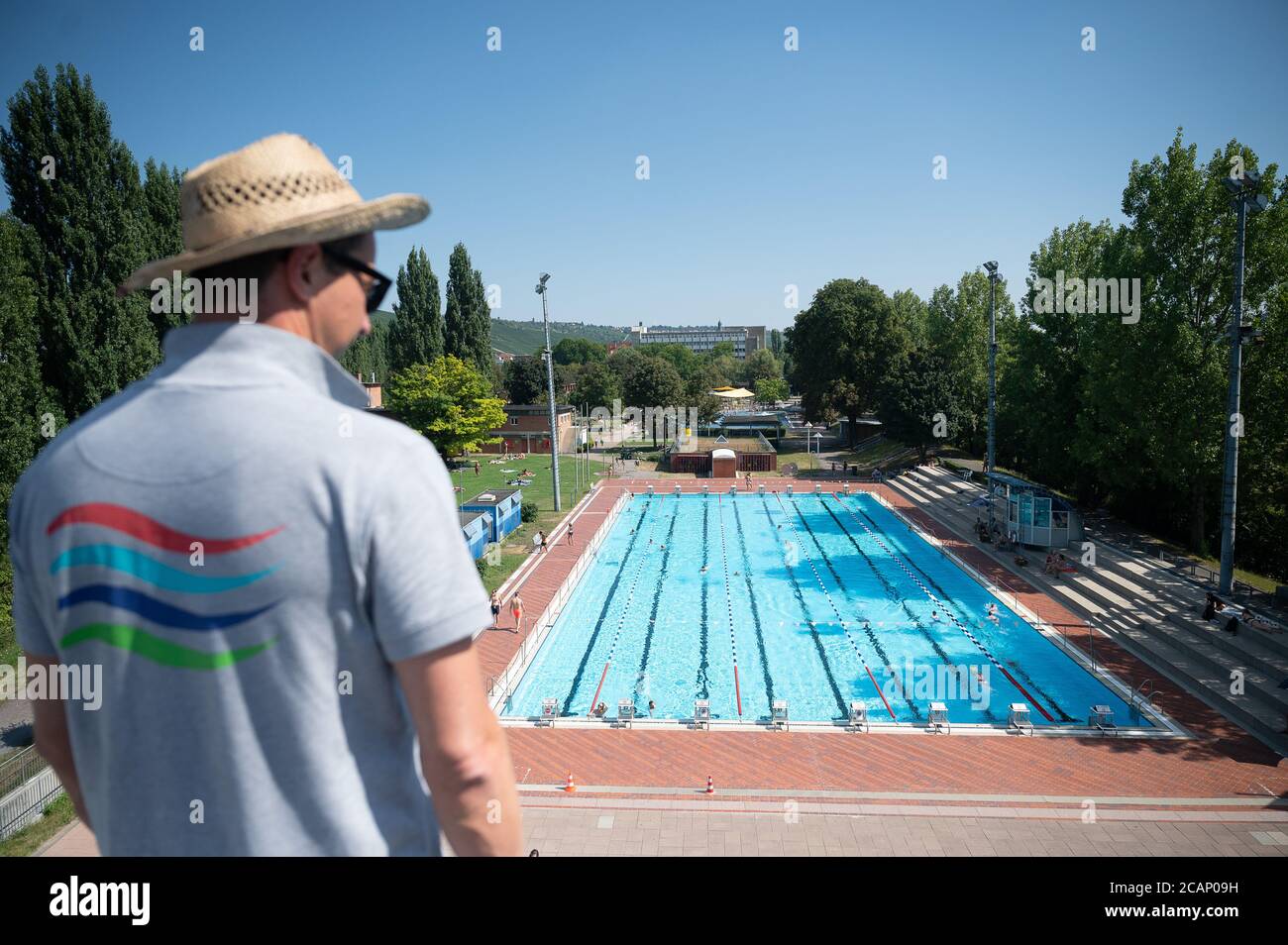 07 August 2020, Baden-Wuerttemberg, Stuttgart: A lifeguard stands in the Inselbad on the ten-meter tower. Photo: Sebastian Gollnow/dpa Stock Photo