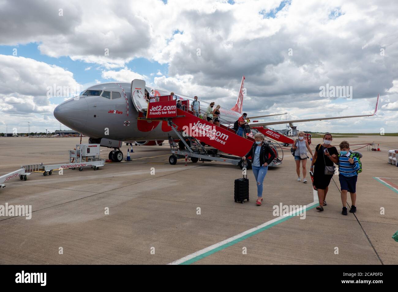Picture dated August 1st 2020 shows Jet2 passengers leaving a plane at London Stansted from Ibiza  Airport.The company today (Aug 7) announced  it is cancelling more flights to the Balearic Islands.   Jet2 has announced today (Fri) it is cancelling more flights to the Spanish islands, criticising the 'uncertainty' of the government's blanket ban.   The Foreign and Commonwealth Office is currently advising against all but essential travel to both the Spanish mainland and the Spanish islands. Stock Photo