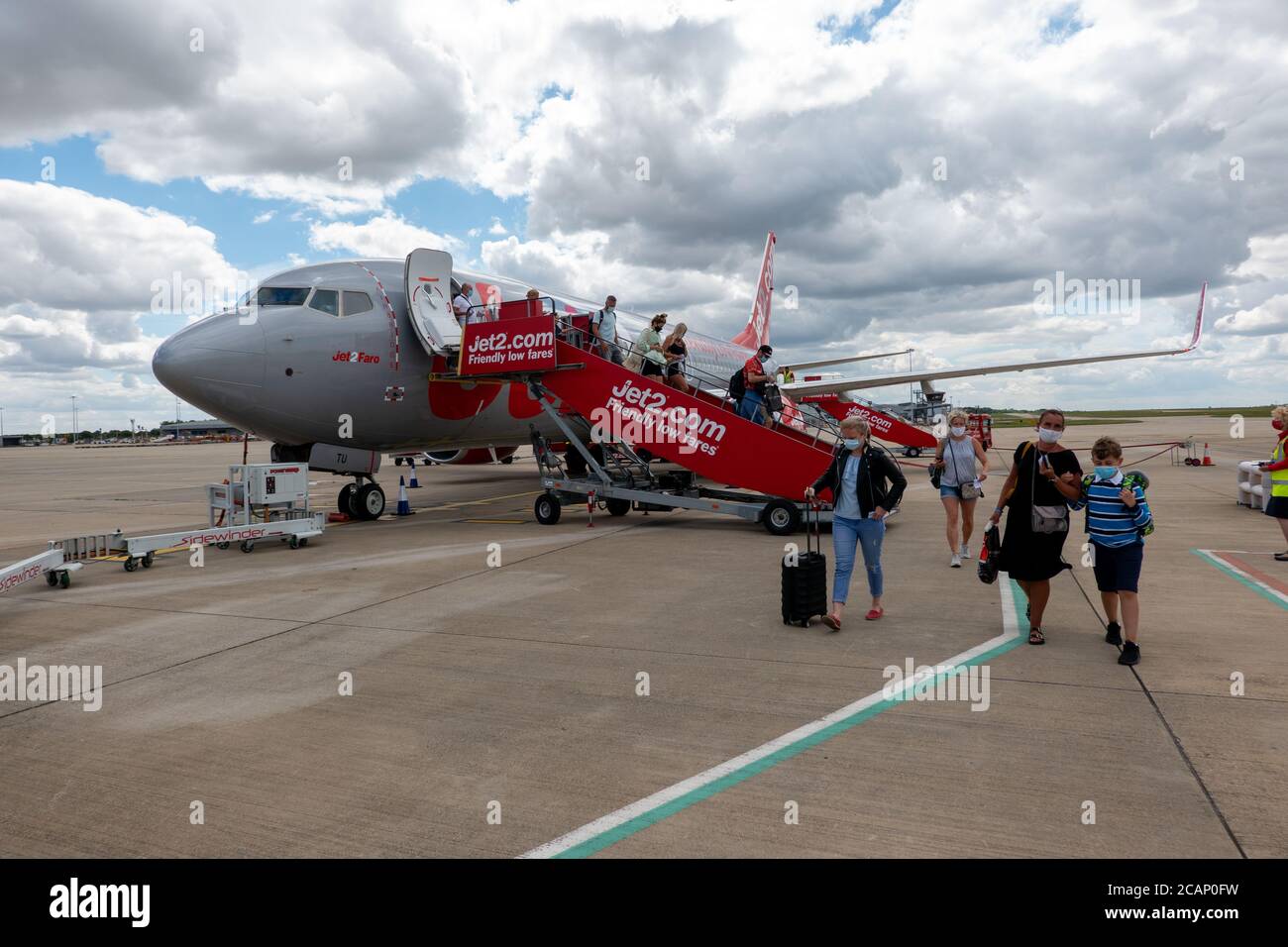 Picture dated August 1st 2020 shows Jet2 passengers leaving a plane at London Stansted from Ibiza  Airport.The company today (Aug 7) announced  it is cancelling more flights to the Balearic Islands.   Jet2 has announced today (Fri) it is cancelling more flights to the Spanish islands, criticising the 'uncertainty' of the government's blanket ban.   The Foreign and Commonwealth Office is currently advising against all but essential travel to both the Spanish mainland and the Spanish islands. Stock Photo