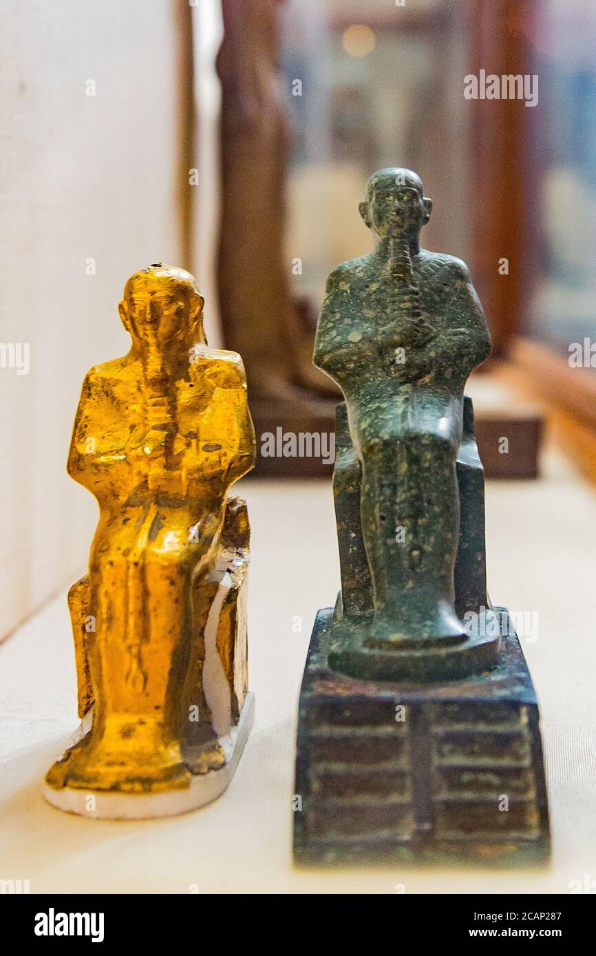 Egypt, Cairo, Egyptian Museum, statue of the god Ptah, seated on a throne, on top of stairs. In breccia stone. Originally enveloped into a gold foil. Stock Photo