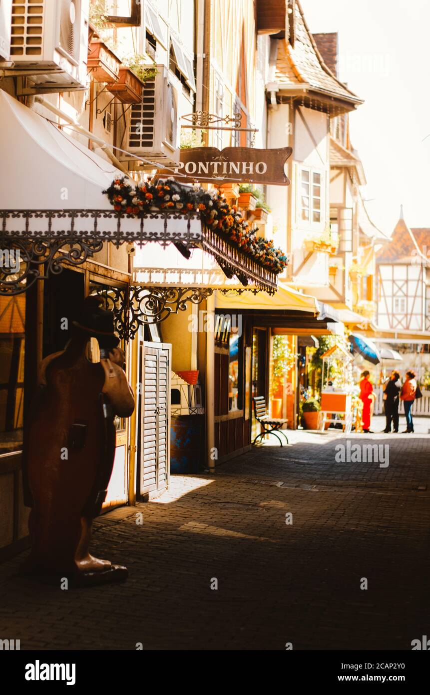 Vertical shot of the side view of shop entrances decorated with flowers and a sign to Pontinho shop in Vila Germânica, Blumenau - Brazil during the af Stock Photo