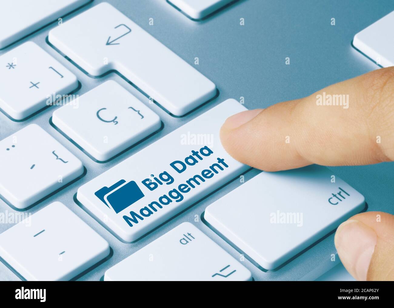 Big Data Management Written on Blue Key of Metallic Keyboard. Finger pressing key. Stock Photo
