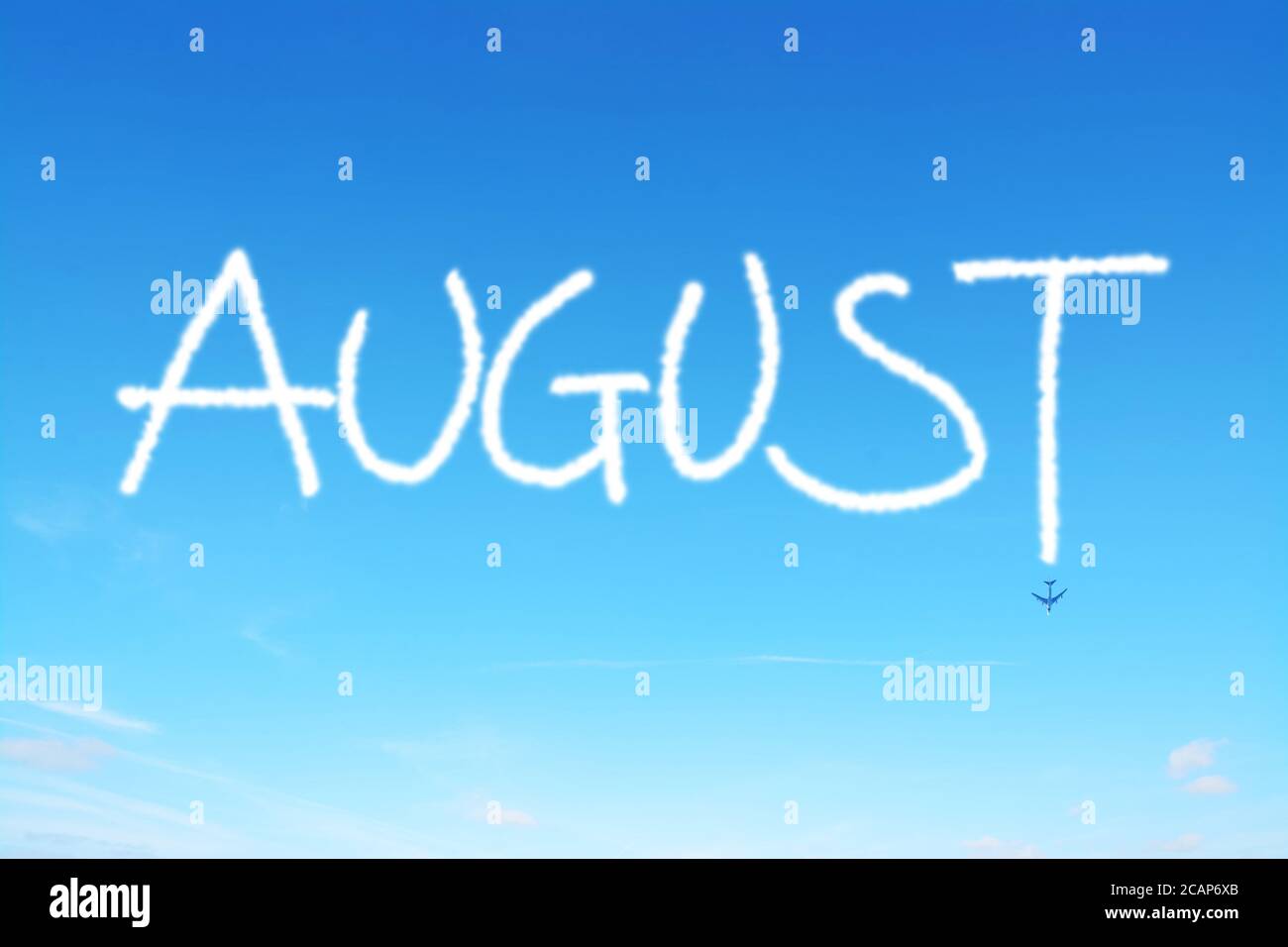 august written in the sky with contrails Stock Photo