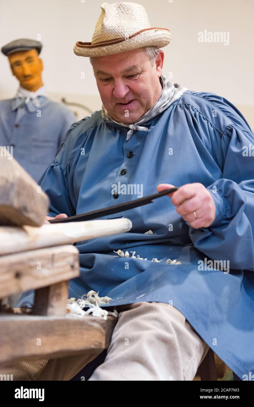 A guide demonstrating traditional ways of carving wood at the Sainte-Marie-du-Lac-Nuisement in Champagne-Aube, France Stock Photo