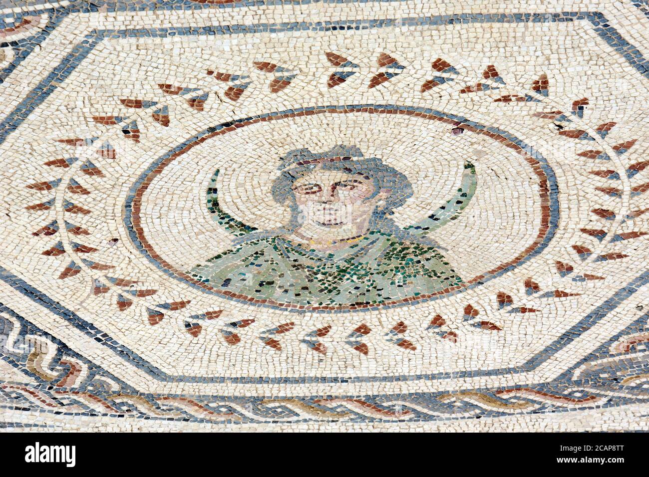 Spain, Andalusia, Seville province, Santiponce. Roman city of Italica. Founded in 206 BC by the Roman general Scipio. House of the Planetarium. Mosaic which represents the seven stars of the solar system known at that time by the Romans. Each planet is personified by a god, in turn, symbolises a day of the week. Detail of Luna or Selene, Moon goddess (Monday). Depicted with long hair and large crescent moon. Stock Photo