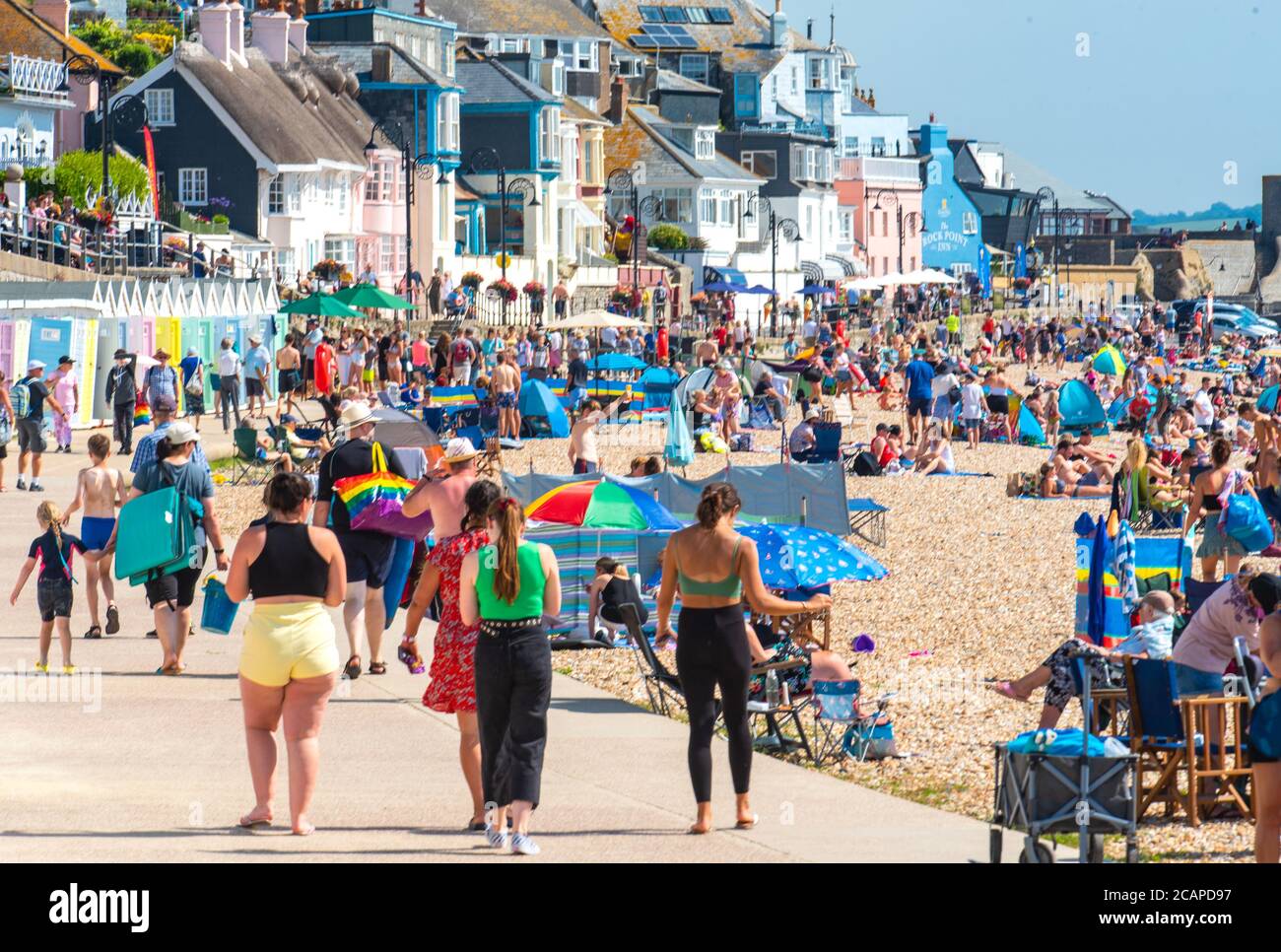 Lyme Regis, Dorset, UK. 8th Aug, 2020. UK Weather: Crowds of holidaymakers and sunseekers pack out the beach at the seaside resort of Lyme Regis, Dorset to bask in another day of sizzling hot sunshine as the heatwave continues. Lyme Regis was full to capacity by 11.30am. Credit: Celia McMahon/Alamy Live News Stock Photo