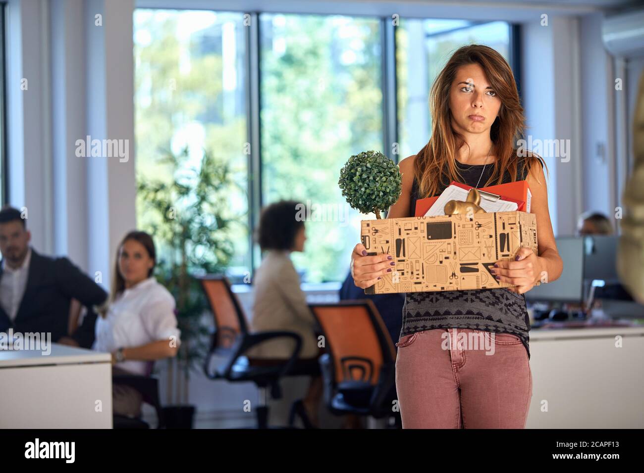 Young woman being sad because she got fired from the office Stock Photo
