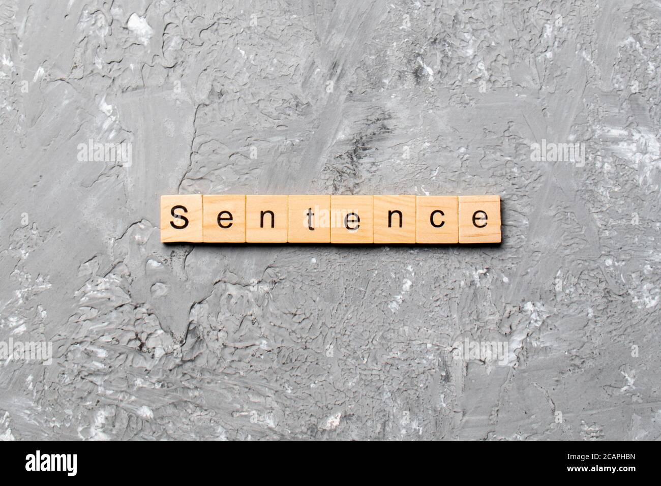 Sentence word written on wood block. Sentence text on table, concept