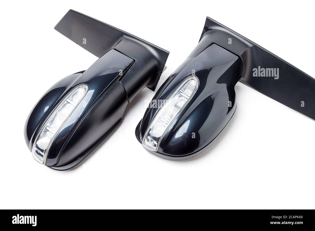 Closeup on a pair of side mirrors from a minibus with turn signal