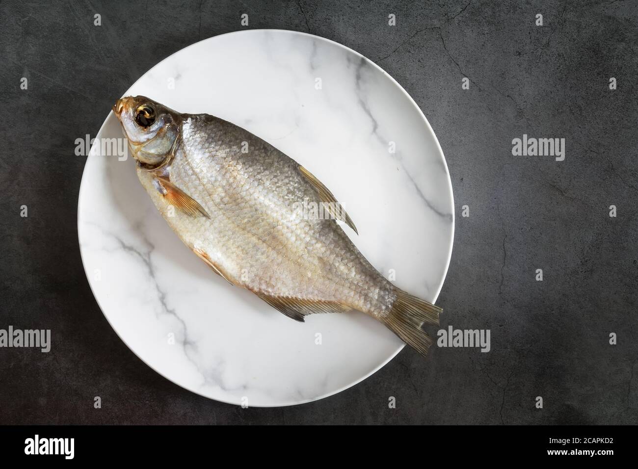 Salted and dried fish on a plate Stock Photo