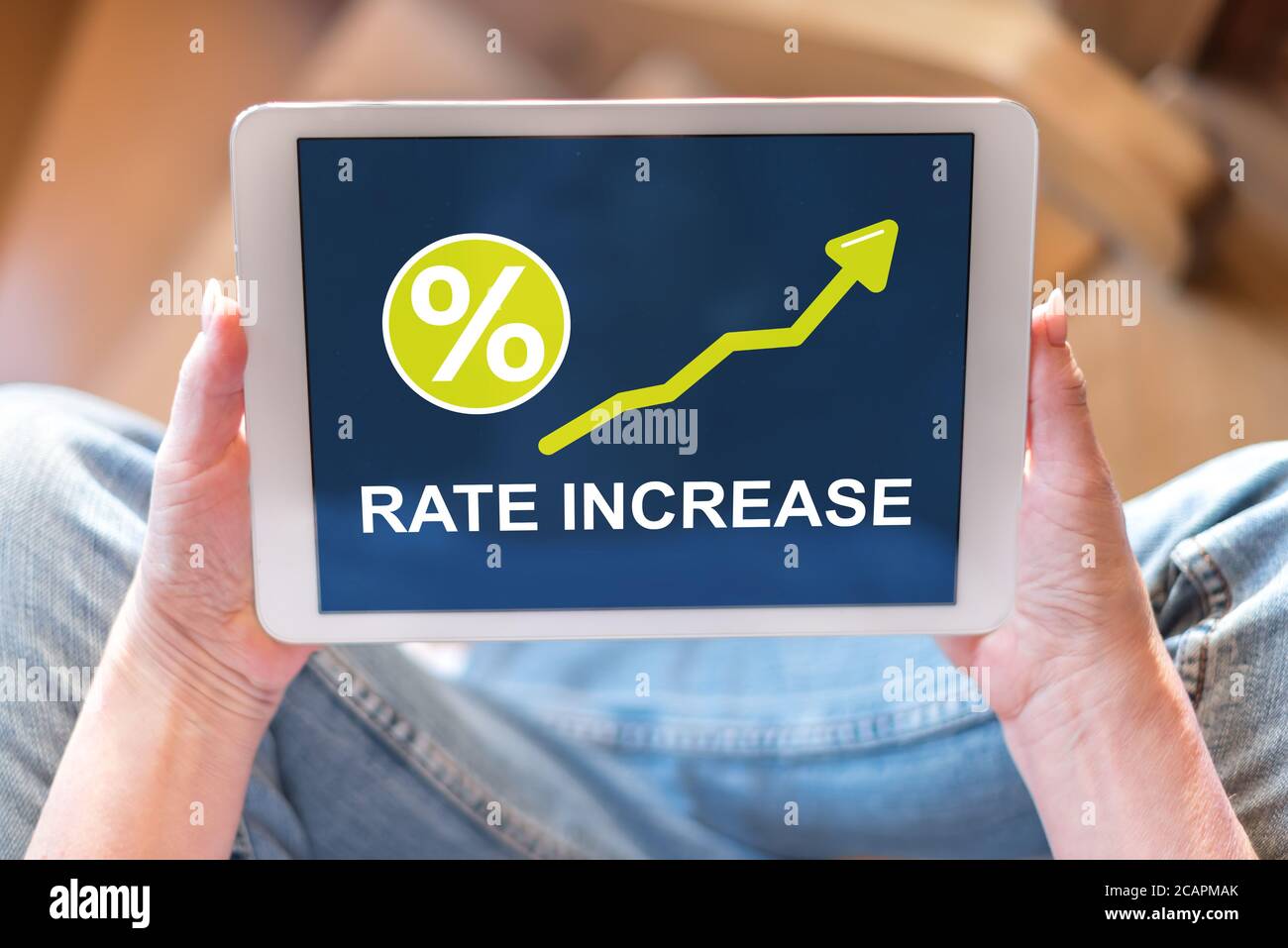 Tablet screen displaying a rate increase concept Stock Photo - Alamy
