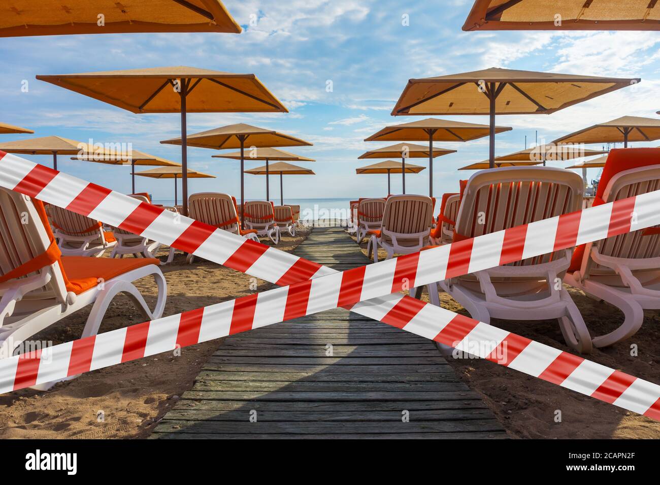 Protective tape on background beach with sun loungers and parasols in Kemer Stock Photo