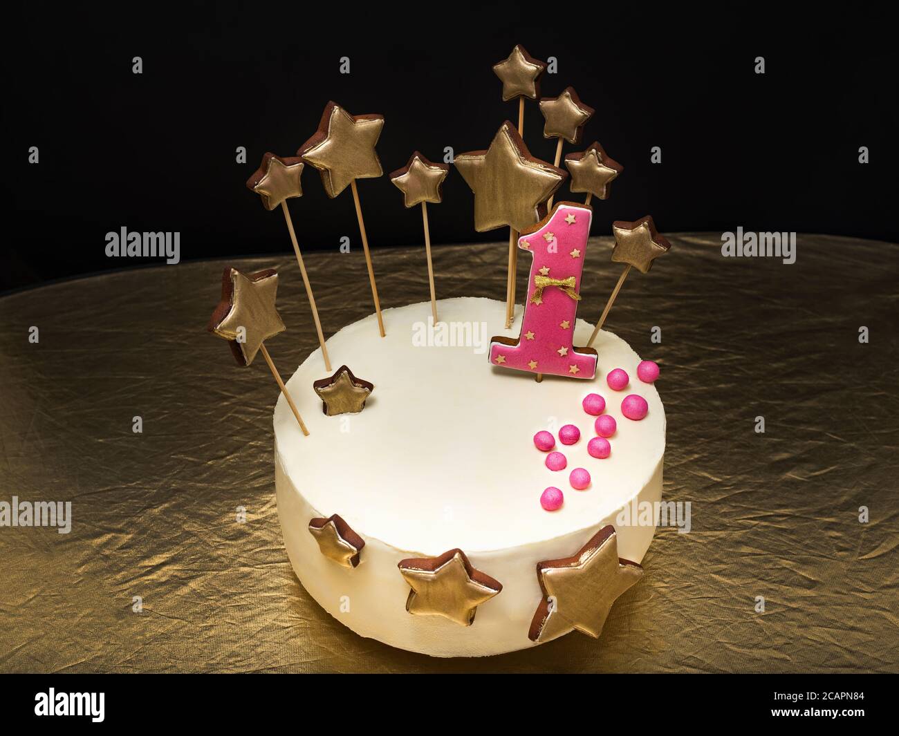 Birthday cake decorated with pink number 1 and gold stars of ...
