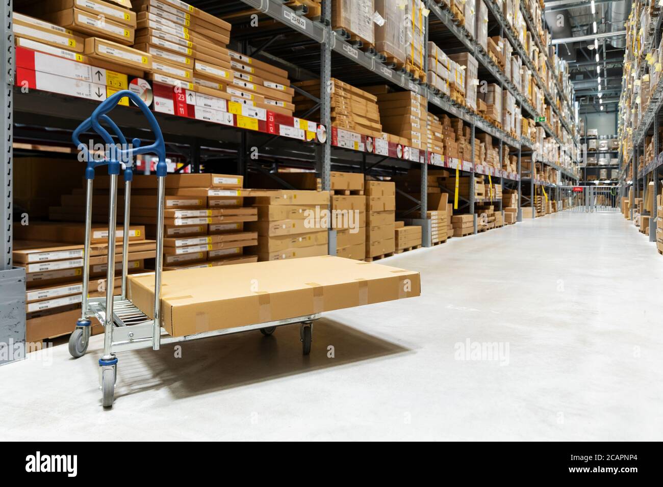 warehouse logistics - box on trolley in modern distribution center Stock Photo