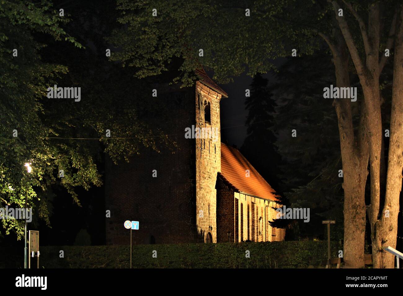 Church with evening lighting with trees in the foreground Stock Photo