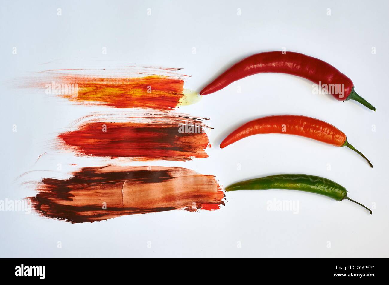 red and green peppers on a white background with paints Stock Photo - Alamy
