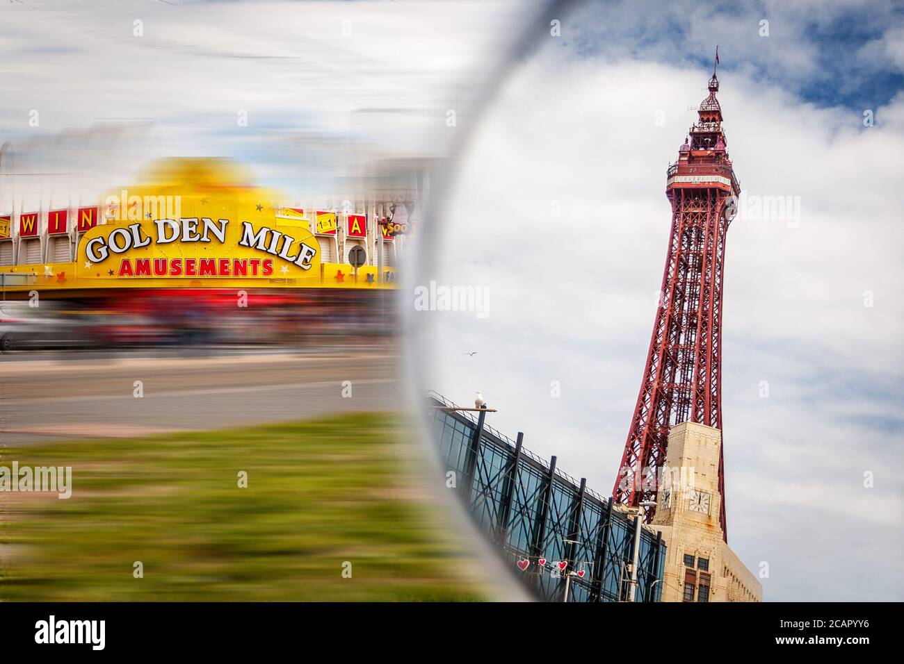 The World famous Blackpool tower seen through a mirror sat on the golden mile. Stock Photo