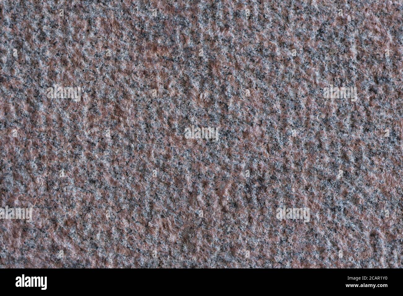 Roughly processed granite slab. Top view. Backgrounds and textures. Close up. Stock Photo