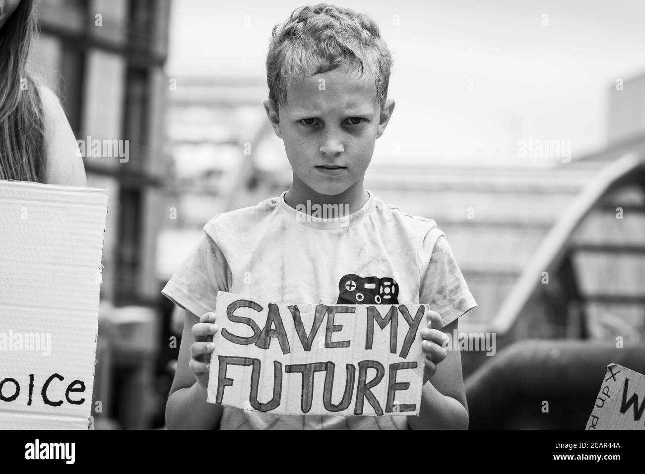 Sheffield, England, UK - Aug 8th 2020 - Kid holding protest banner. Demonstration to protest against restrictive measures. Stand up X protest. Stock Photo