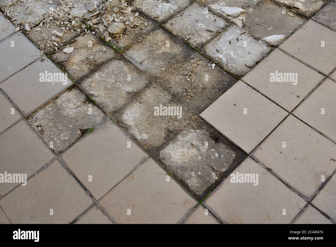 Chipping off old tiles on the terrace during renovation, replacing them