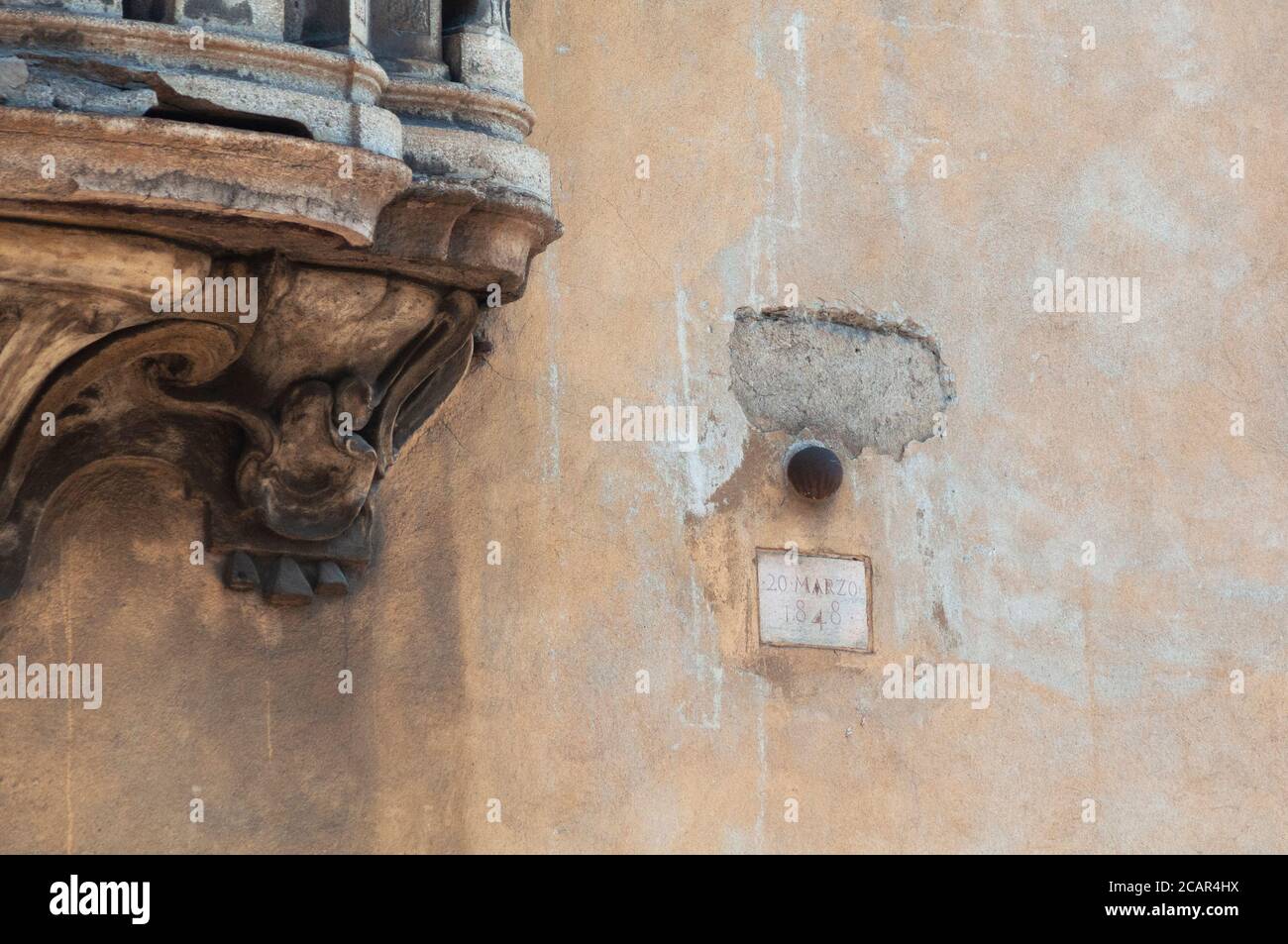 Italy, Lombardy, Milan, Corso di Porta Romana Street, Five Days of Milan, Cannon Ball Embedded in the Wall Stock Photo