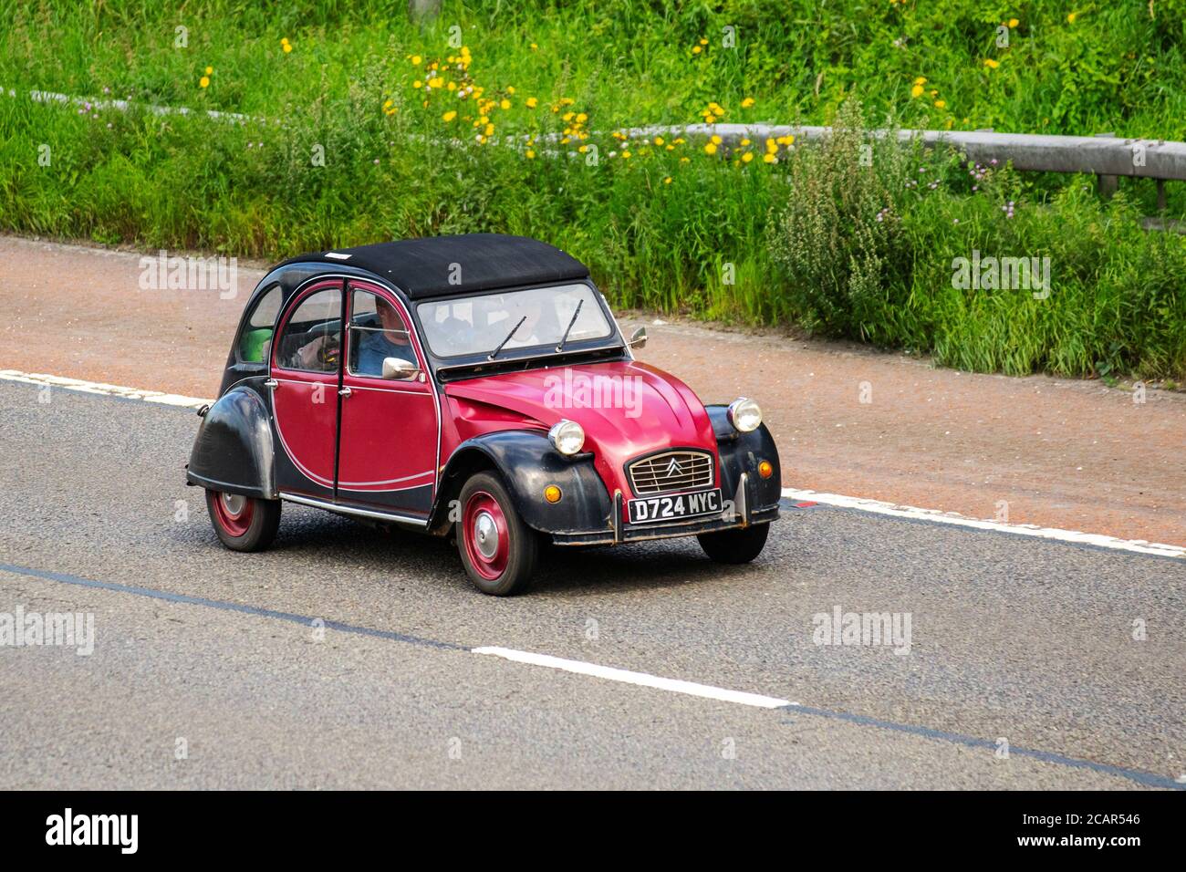 1987 80s black maroon Citroën 2 CV6; Vehicular traffic moving vehicles, air-cooled front-engine, small compact city car, front-wheel-drive economy car driving vehicle on UK roads, classic French motors, motoring on the M6 motorway highway network. Stock Photo