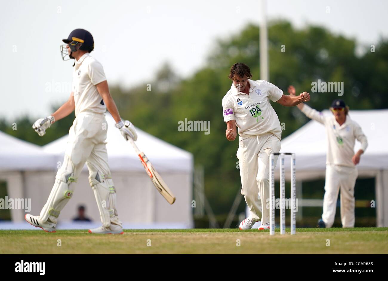 Hampshire's James Fuller (right) celebrates the wicket of Middlesex's Martin Andersson (left) during day one of The Bob Willis Trophy match at Radlett Cricket Club, Radlett. Stock Photo