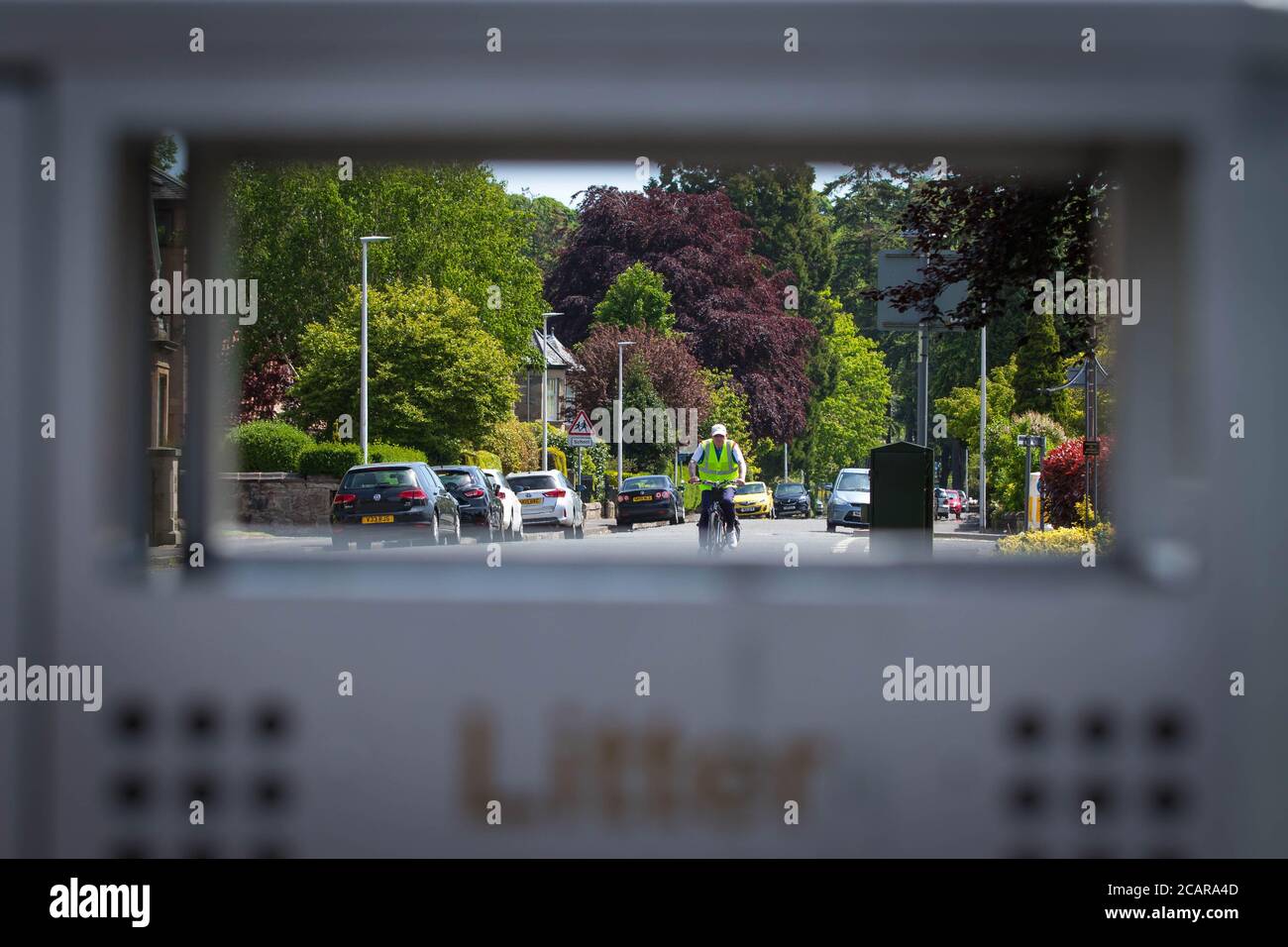 Cyclist shot through dustbin Stock Photo