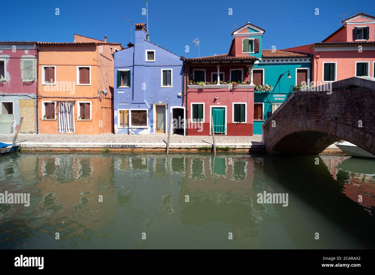 Burano island, Venetian Lagoon, Venice, Italy, panorama with the typical coloured homes frontages and a bridge overlooking a canal in the town centre Stock Photo
