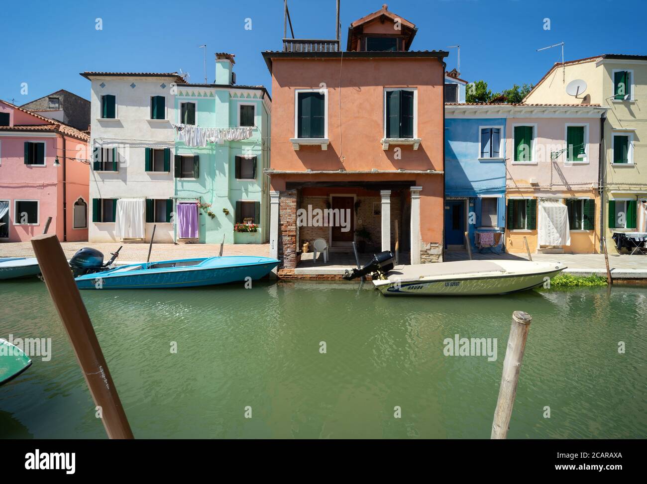 Burano island, Venetian Lagoon, Venice, Italy, panorama with the typical coloured fisherman homes frontages overlooking a canal with small boats Stock Photo