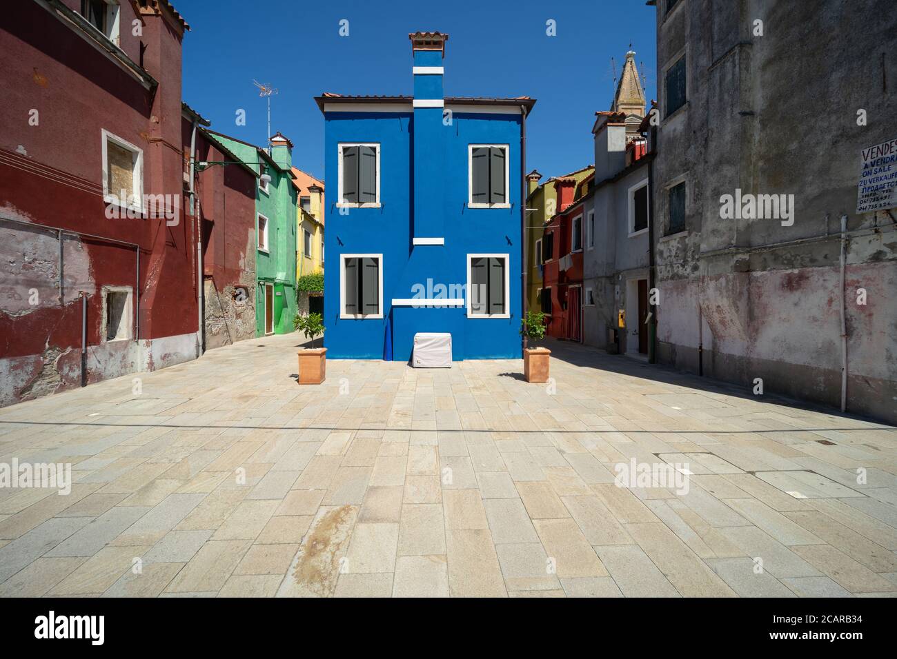 Burano island, Venetian Lagoon, Venice, Italy, a small blue coloured home on a campo square in the town centre Stock Photo