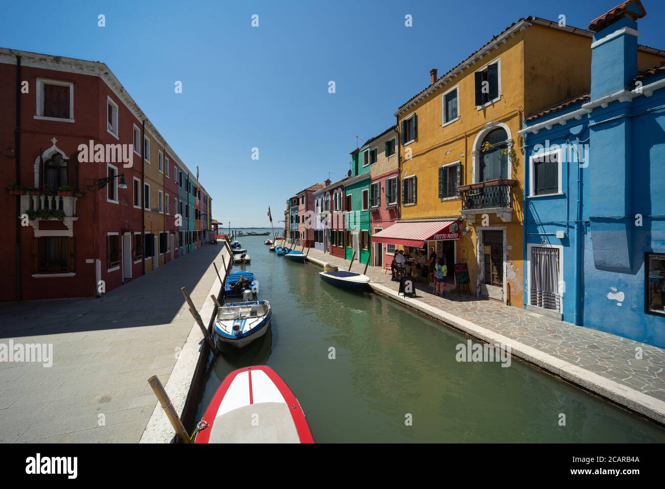 Burano island, Venetian Lagoon, Venice, Italy, panorama with the typical coloured homes frontages overlooking a canal in the town centre Stock Photo