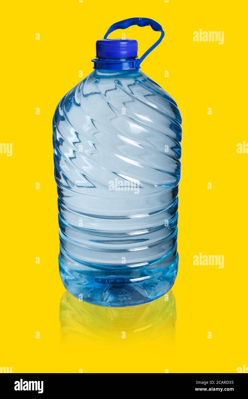 Big bottle of water on a gold background. Five liters Stock Photo