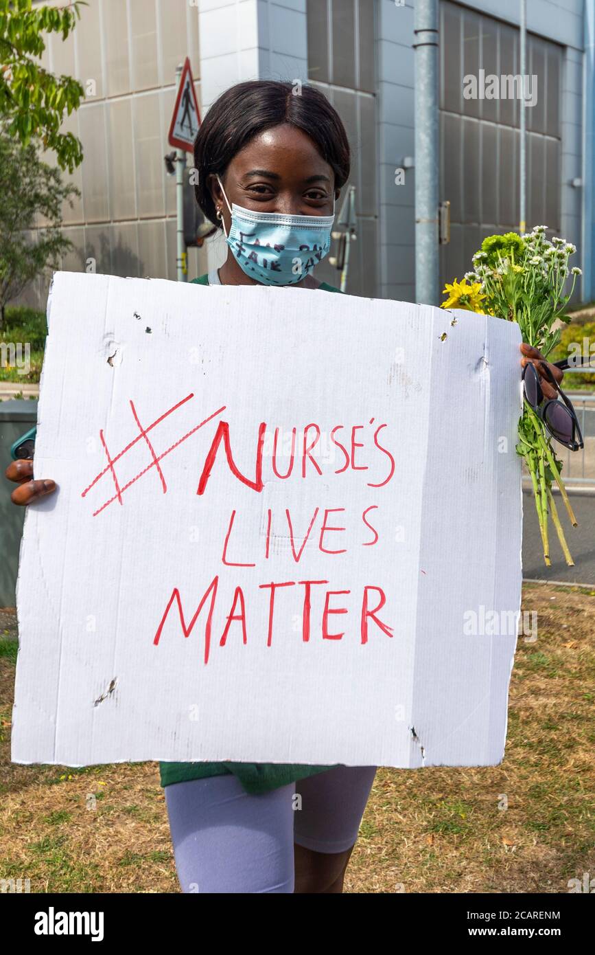 Black female at NHS protest against missing out public sector pay increase and to honour staff killed by COVID-19. Play on black lives matter slogan Stock Photo