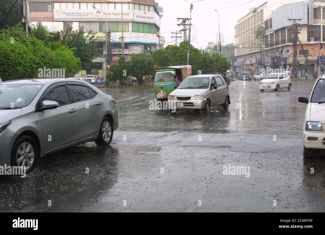 Commuters are passing through a road during heavy downpour of monsoon season, at Shimla Hill in Lahore on Saturday, August 8, 2020. Stock Photo