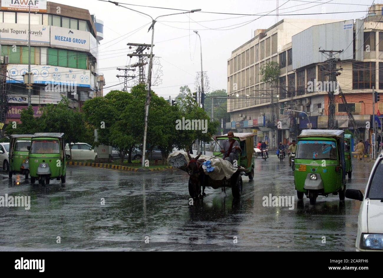Commuters are passing through a road during heavy downpour of monsoon season, at Shimla Hill in Lahore on Saturday, August 8, 2020. Stock Photo