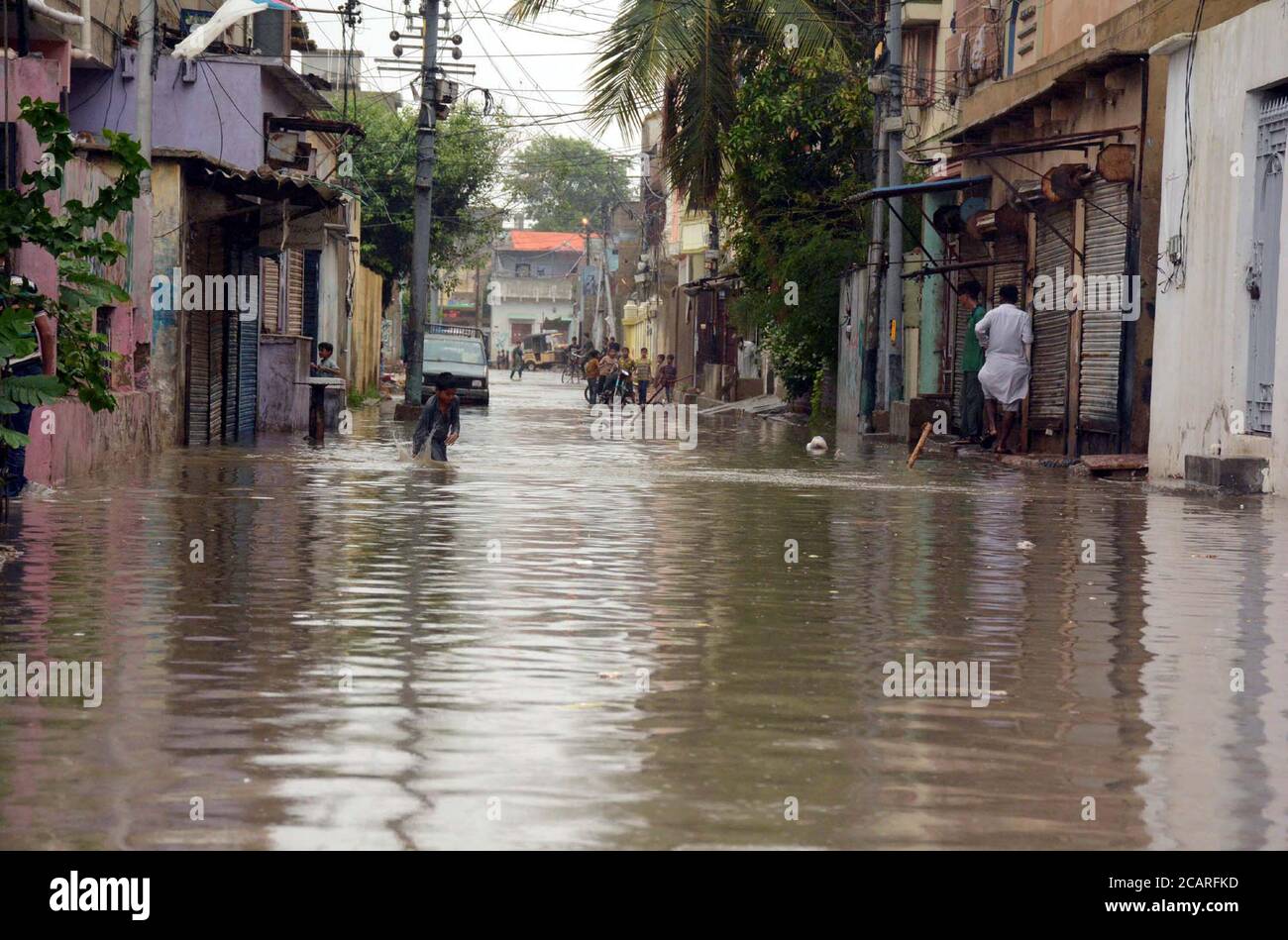 View of stagnant rainwater at a street caused by heavy downpour of monsoon season due to poor sewerage system creating problems for residents showing the negligence of concerned department, at Y area of Korangi in Karachi on Saturday, August 8, 2020. Stock Photo