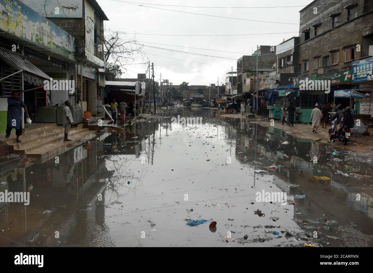 View of stagnant rainwater at a street caused by heavy downpour of monsoon season due to poor sewerage system creating problems for residents showing the negligence of concerned department, at Korangi W-22 area in Karachi on Saturday, August 8, 2020. Stock Photo