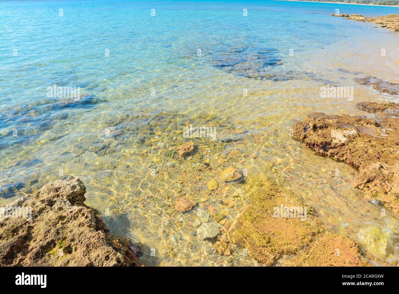 crystal clear water in Mugoni beach, Alghero Stock Photo - Alamy