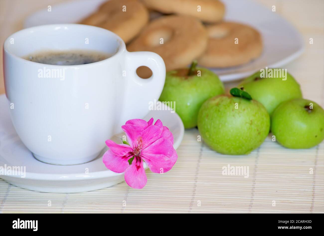 close up of a pink flower on a breakfast set Stock Photo
