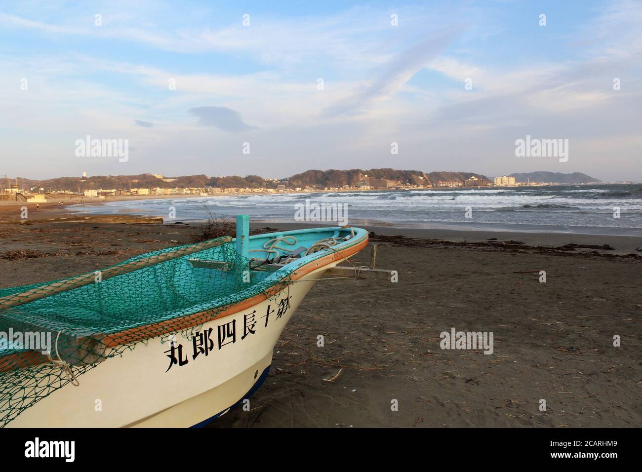 15 March 2018 - Kamakura, Japan: Little fishing boat on cold Kamakura beach. Stock Photo