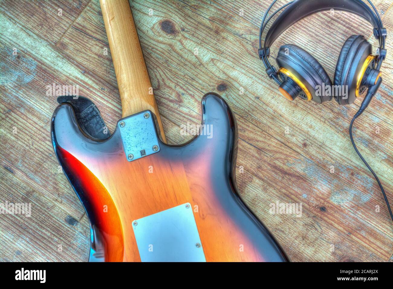electric guitar and headphones on a wooden board. Processed for hdr