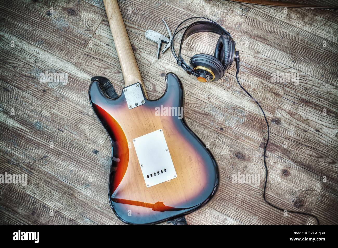 electric guitar and headphones on a wooden board. Processed for hdr