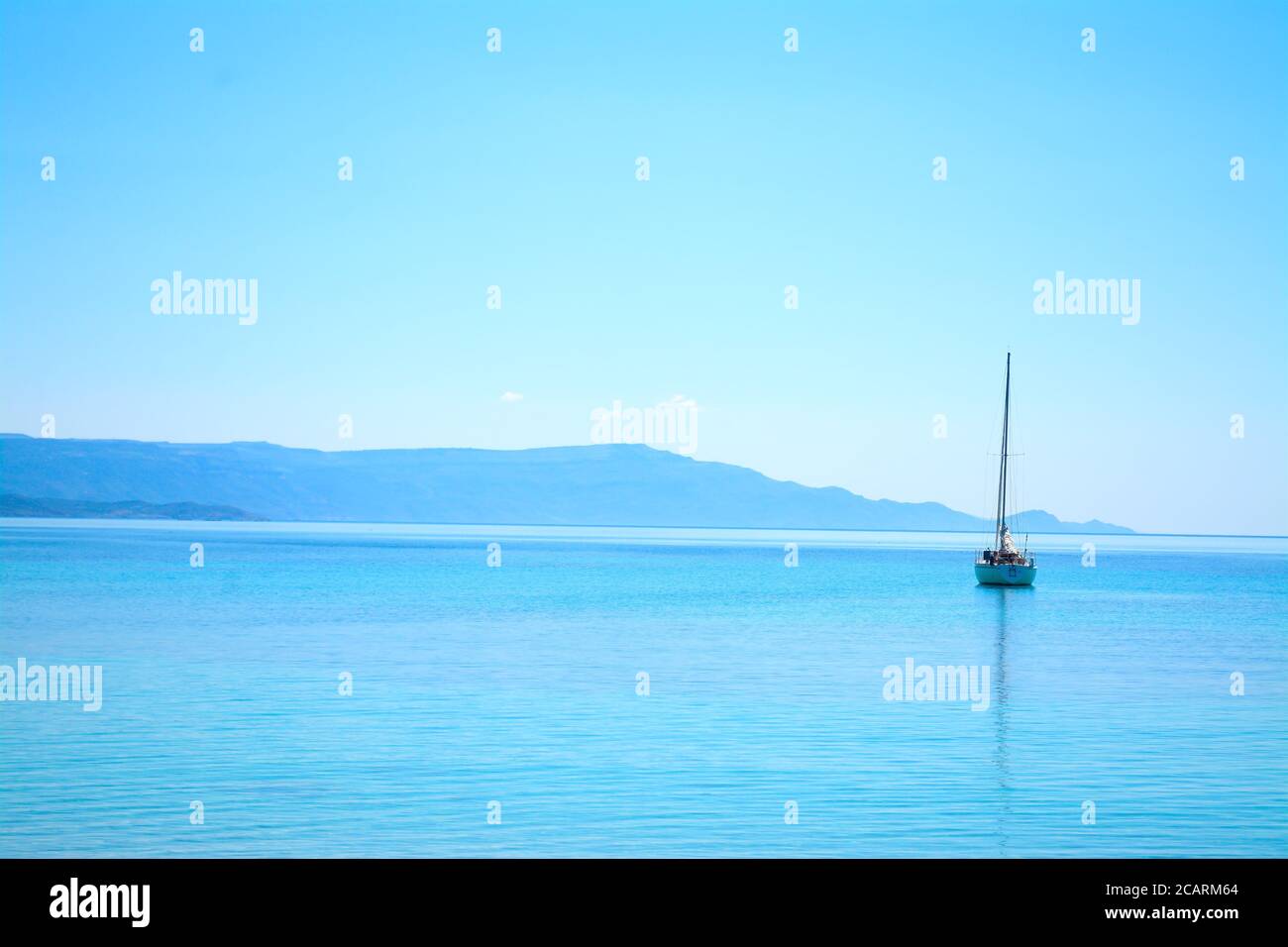 boat alone in the sea on a clear summer day Stock Photo - Alamy