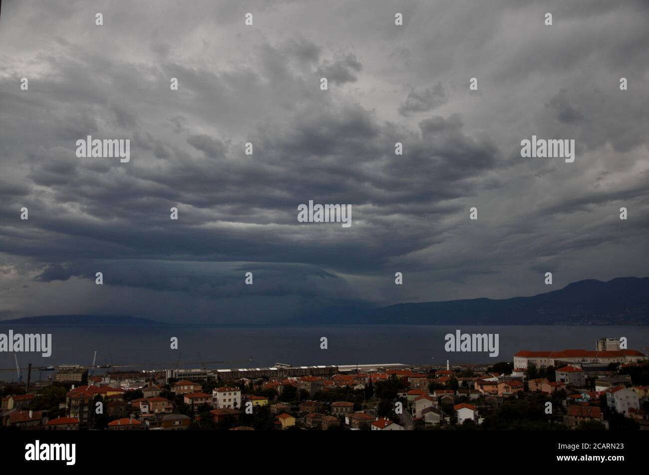 Shelf cloud over Adriatic Sea.shelf cloud is a low-hanging, wedge-shaped formation that occurs along the leading edge of a gust front in a thunderstorm. Stock Photo