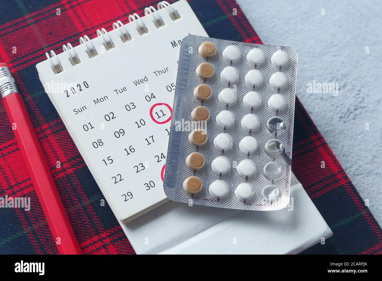 birth control pills , calendar and notepad on table Stock Photo - Alamy