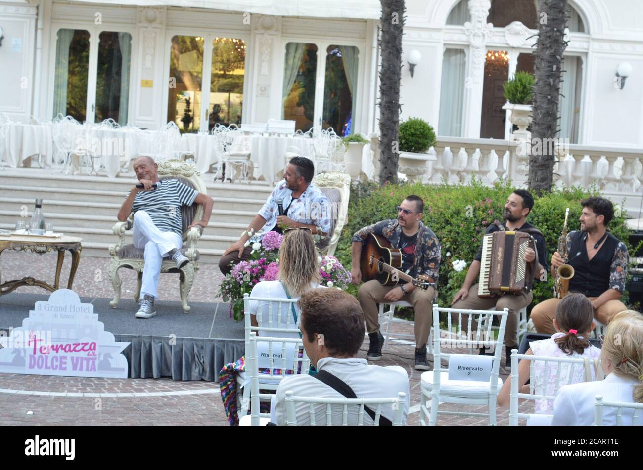 Rimini, ITA. 8th Aug, 2020. (INT) Meeting of two ICONS of Roman and Italian music. August 8, 2020, Rimini, Italy : In the splendid garden of the Grand hotel, a new meeting of La Terrazza della Dolce Vita took place where Giovanni Terzi interviewed Raoul and Mirko Casadei, two big names in Roman and Italian music.Credit: Josi Donelli/Thenews2 Credit: Josi Donelli/TheNEWS2/ZUMA Wire/Alamy Live News Stock Photo