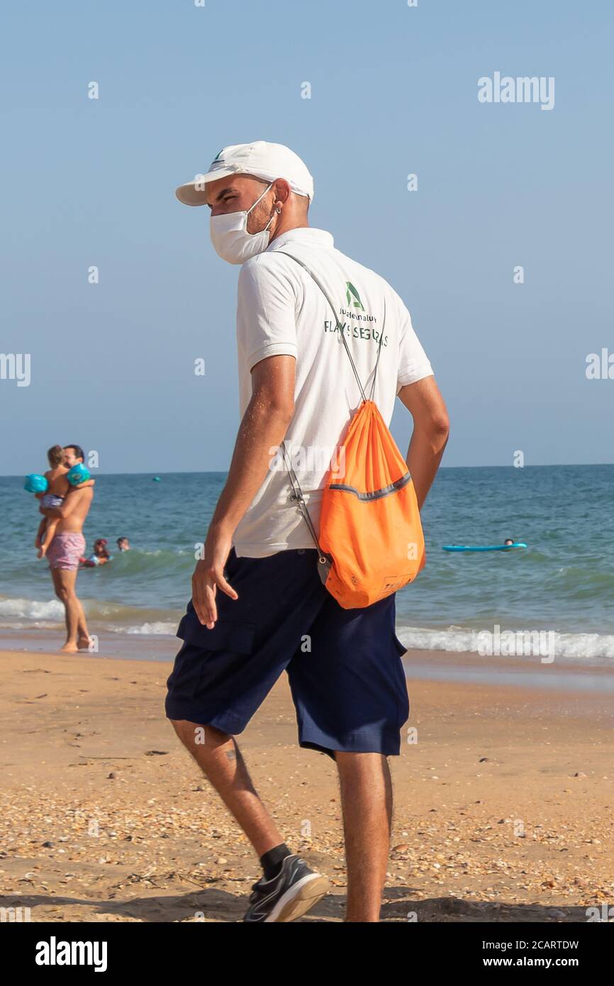 Punta Umbria, Huelva, Spain - August 7, 2020: Beach safety guards of Junta de Andalucia is controlling the social distancing and use of protective mas Stock Photo